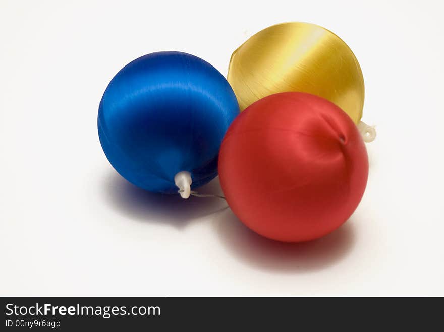 Three assorted colored Christmas Balls isolated against a white background. Three assorted colored Christmas Balls isolated against a white background