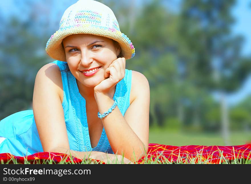 Portrait of young beautiful woman in colorful hat in summer environment. Portrait of young beautiful woman in colorful hat in summer environment