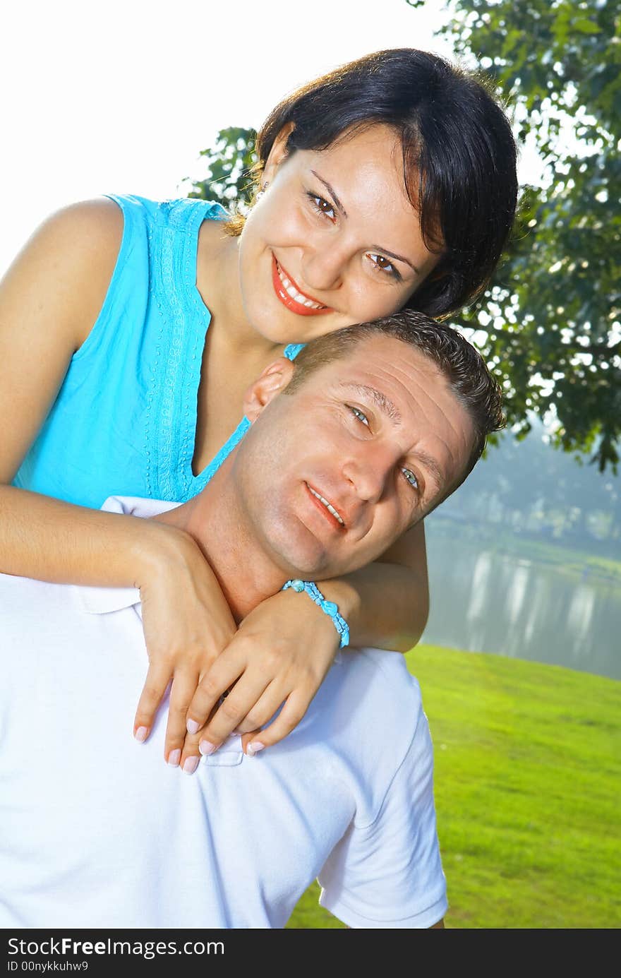 A portrait of attractive couple in summer environment. A portrait of attractive couple in summer environment