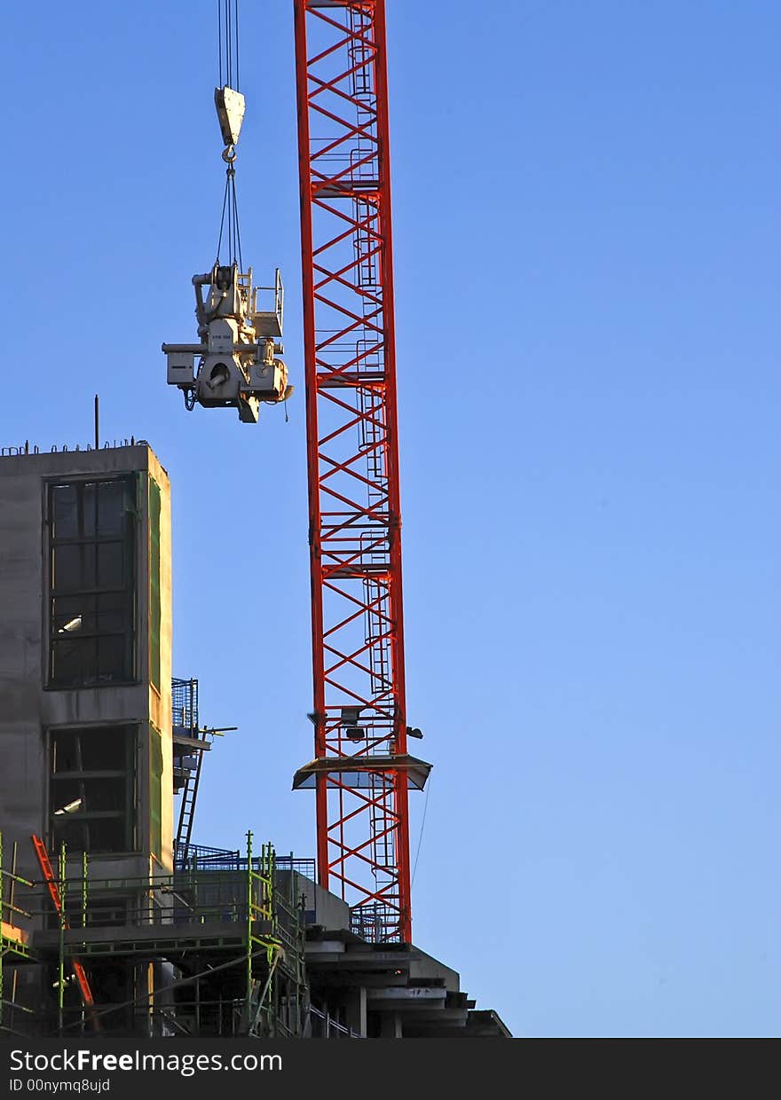 Heavy equipment is lifted on to building site. Heavy equipment is lifted on to building site