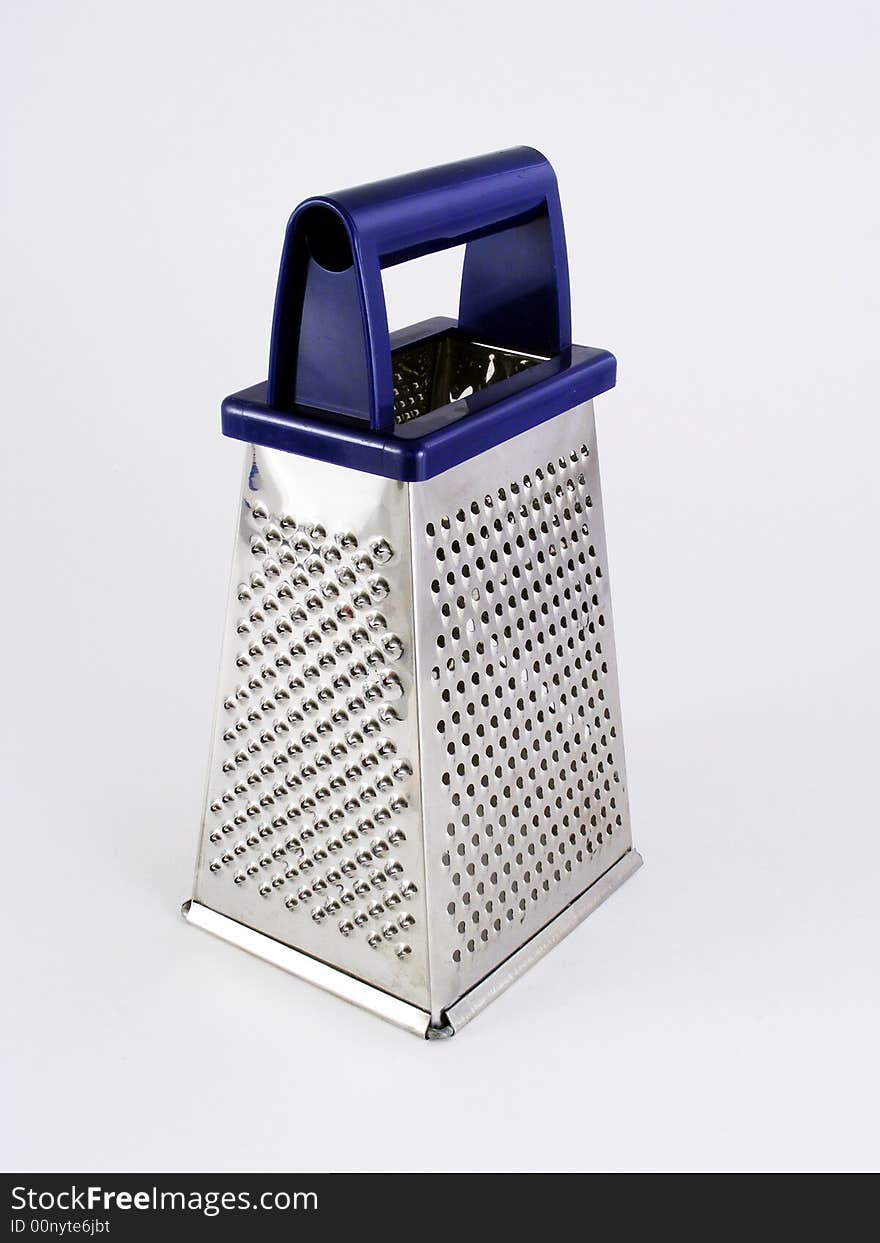 A blue-handled cheese grater against a white background.