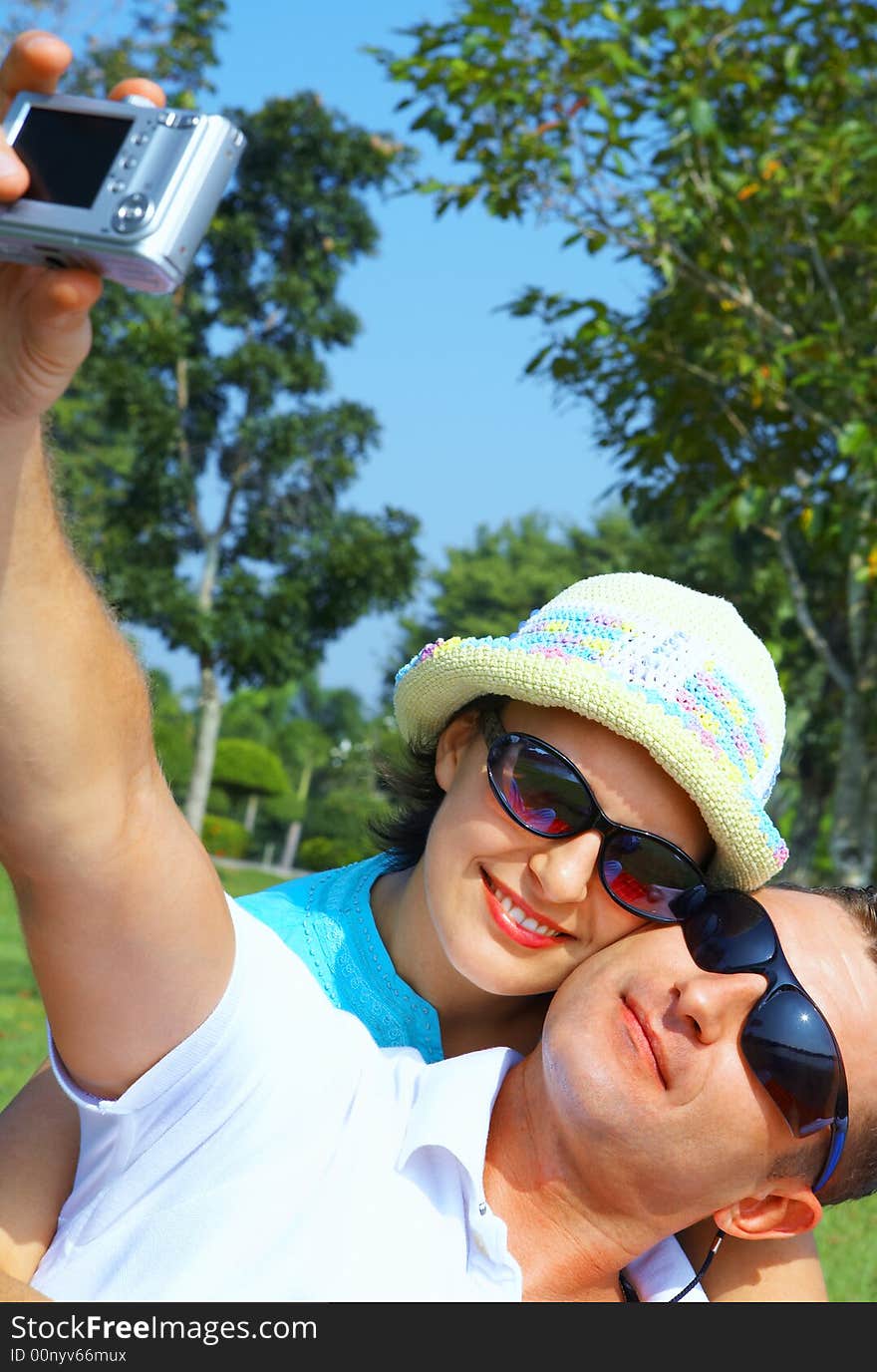 A portrait of attractive couple in summer environment. A portrait of attractive couple in summer environment