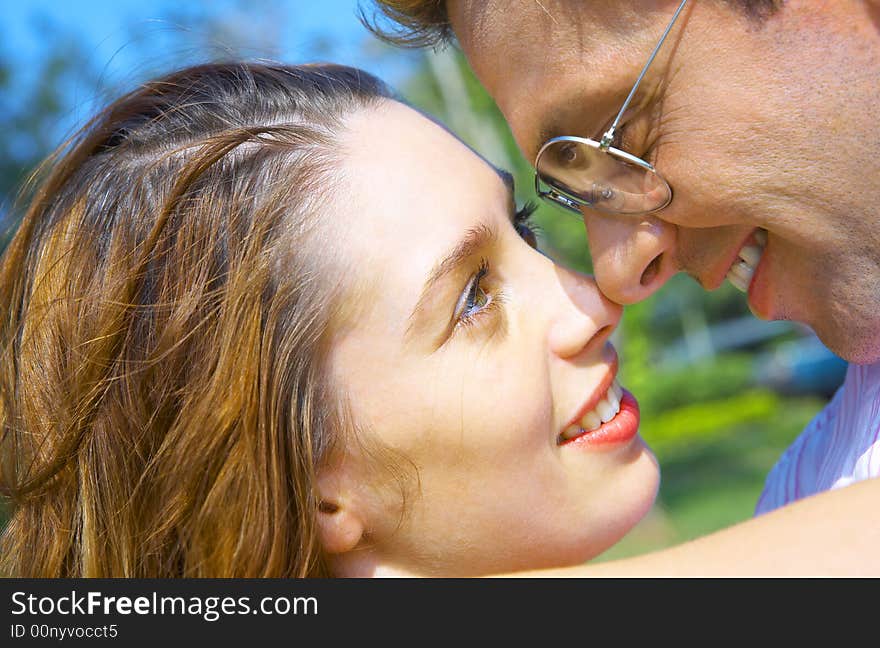 A portrait of attractive couple in summer environment. A portrait of attractive couple in summer environment