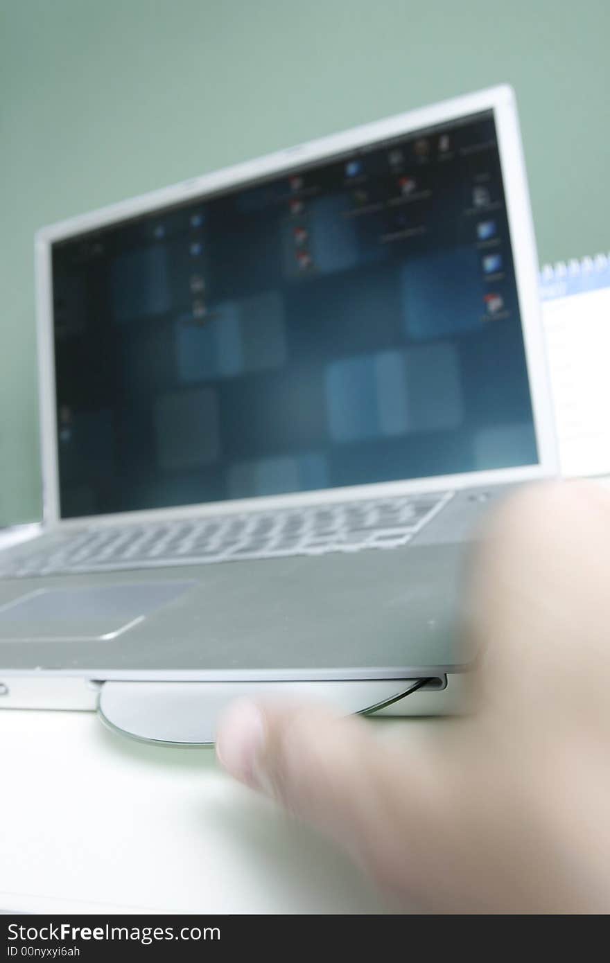 Man placing cd in laptop, close-up. Man placing cd in laptop, close-up