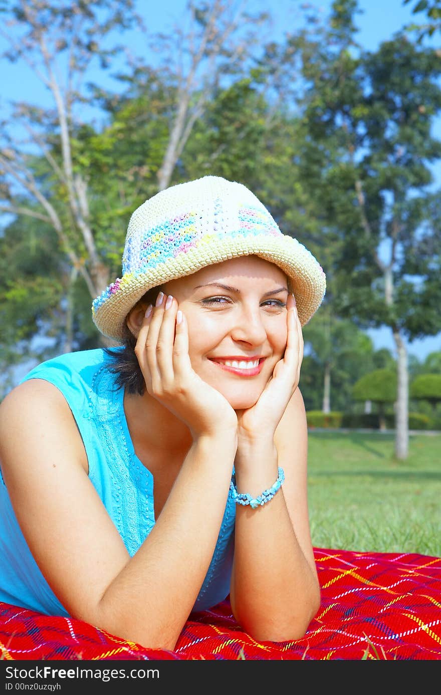 Portrait of young beautiful woman in colorful hat in summer environment. Portrait of young beautiful woman in colorful hat in summer environment