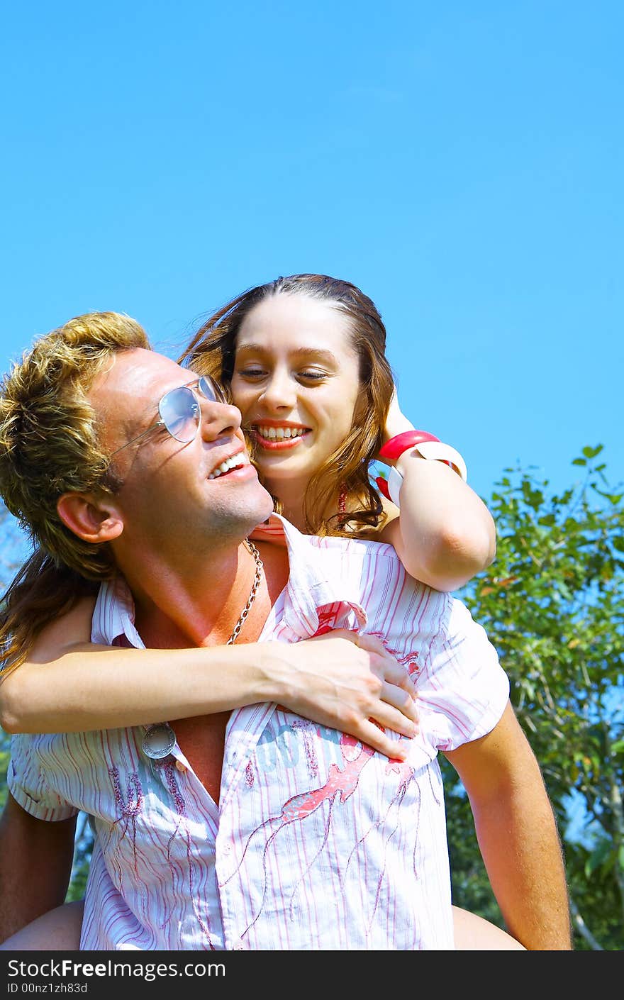 a portrait of attractive couple in summer environment. a portrait of attractive couple in summer environment