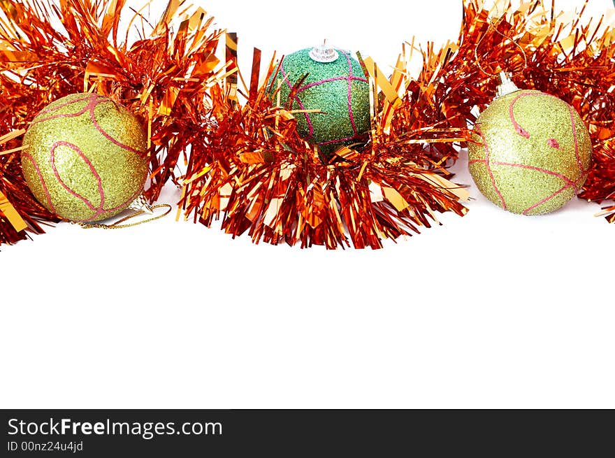 Three Christmas baubles with bright orange tinsel