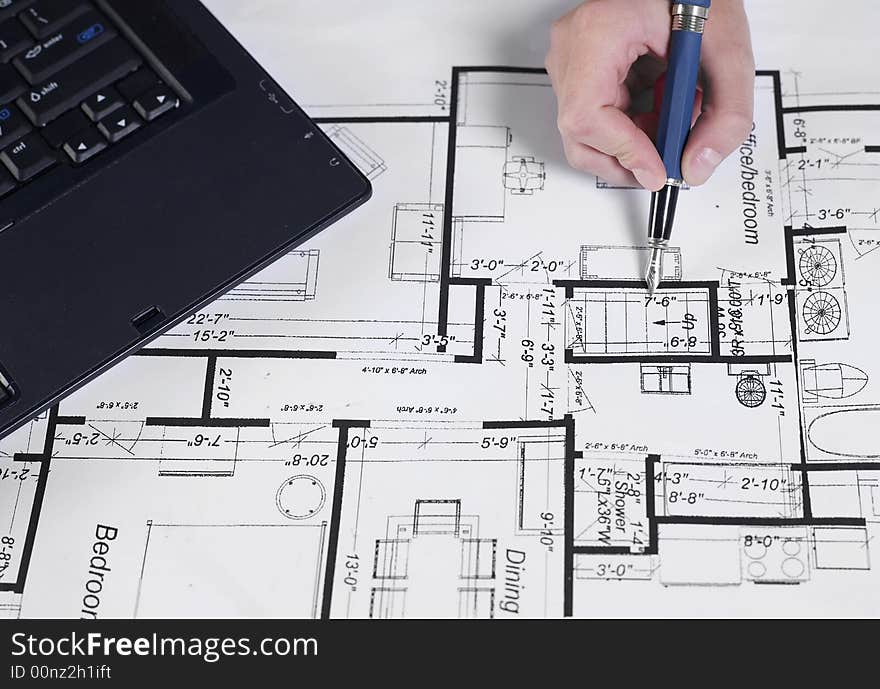 Engineer working on blueprints with pen. Engineer working on blueprints with pen