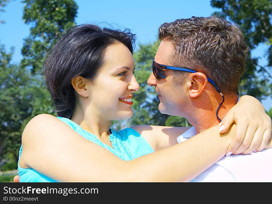 A portrait of attractive couple in summer environment. A portrait of attractive couple in summer environment