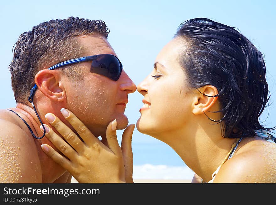 A portrait of attractive couple having fun on the beach. A portrait of attractive couple having fun on the beach