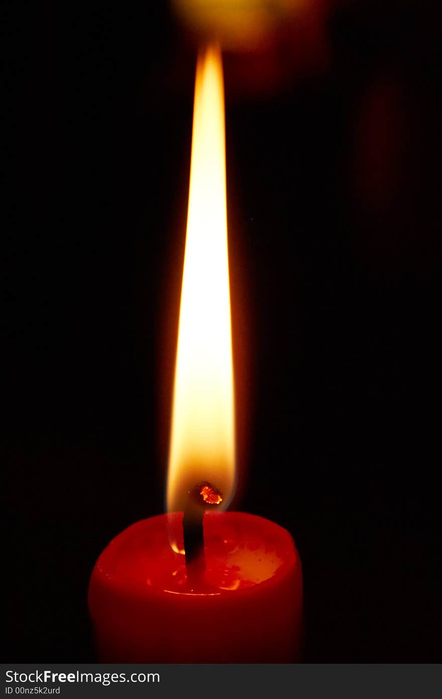 Lighting red candle with dark background. Lighting red candle with dark background