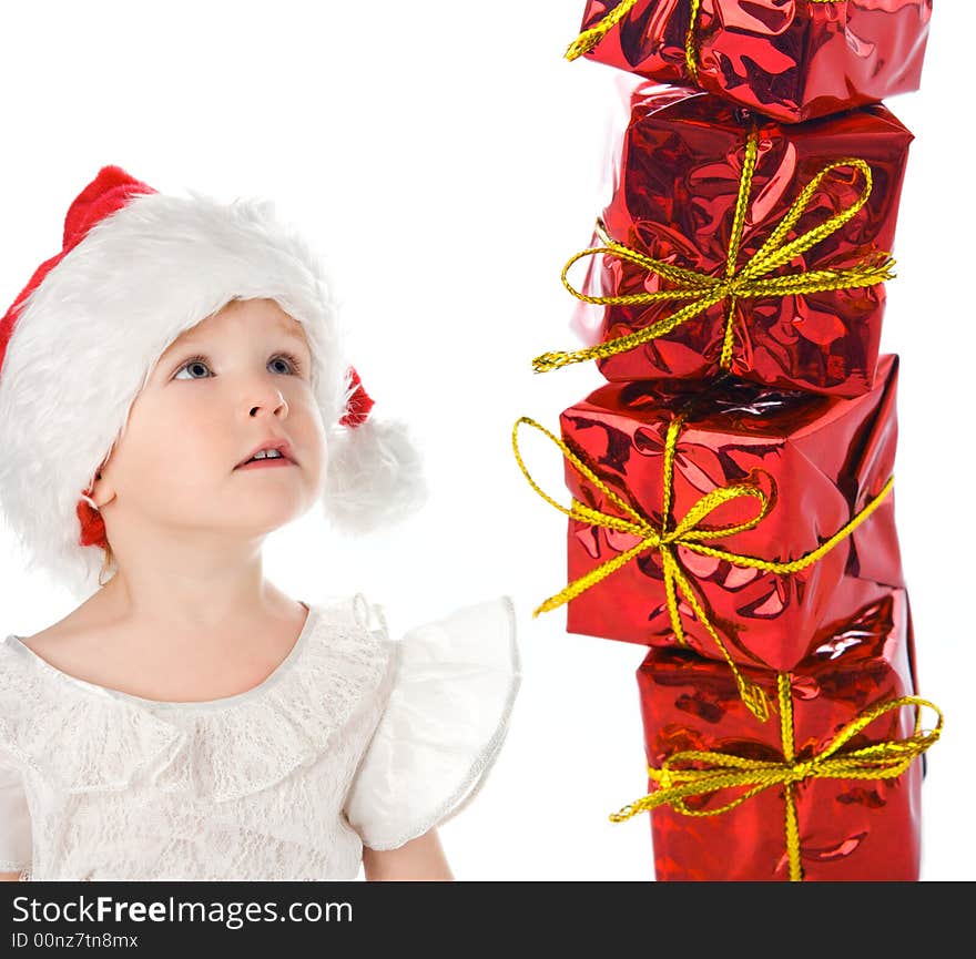 Baby in red hat with box gift over white background