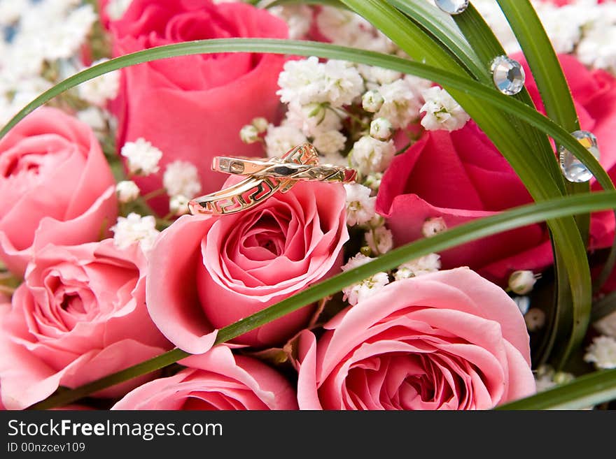 Gold rings and rose bouquet