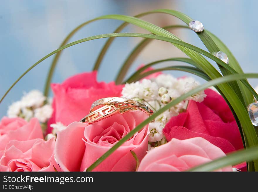 Gold rings and rose bouquet