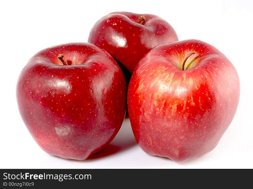 Three red apples on white background.