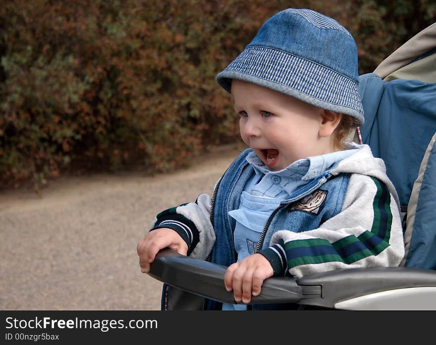 Child riding in a baby carriage