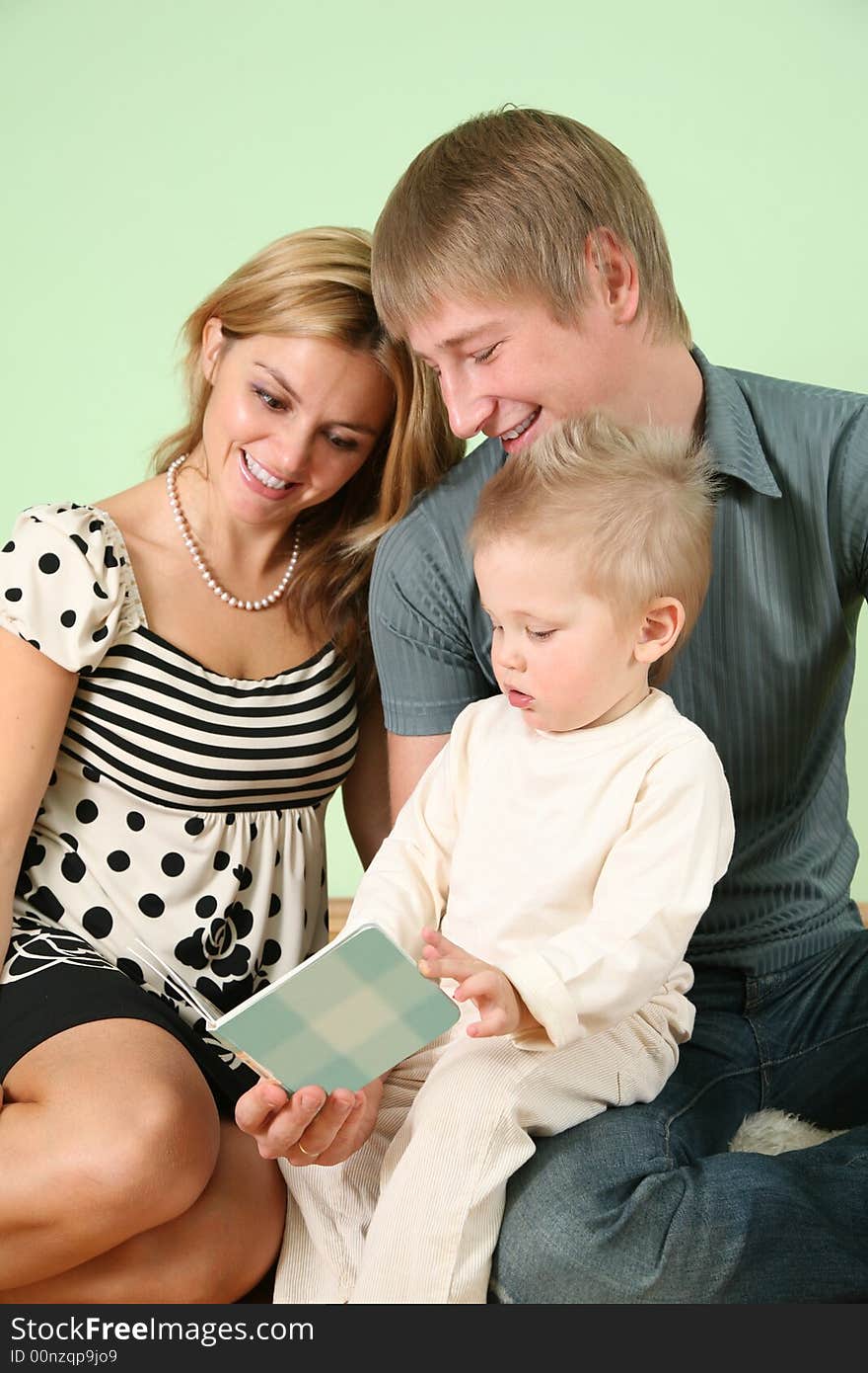 Child with book and parents