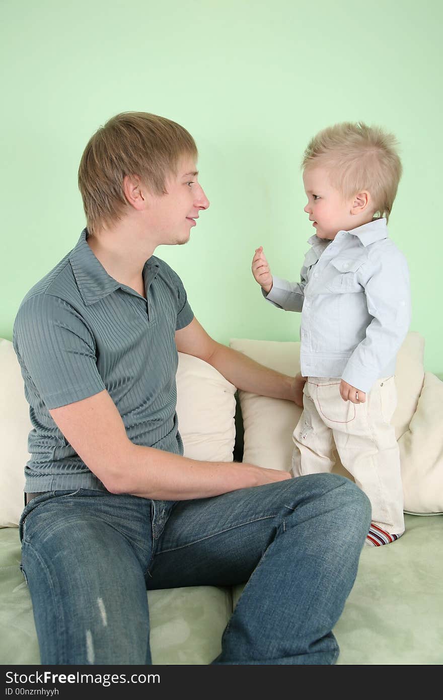 The father with the son on sofa 2. The father with the son on sofa 2