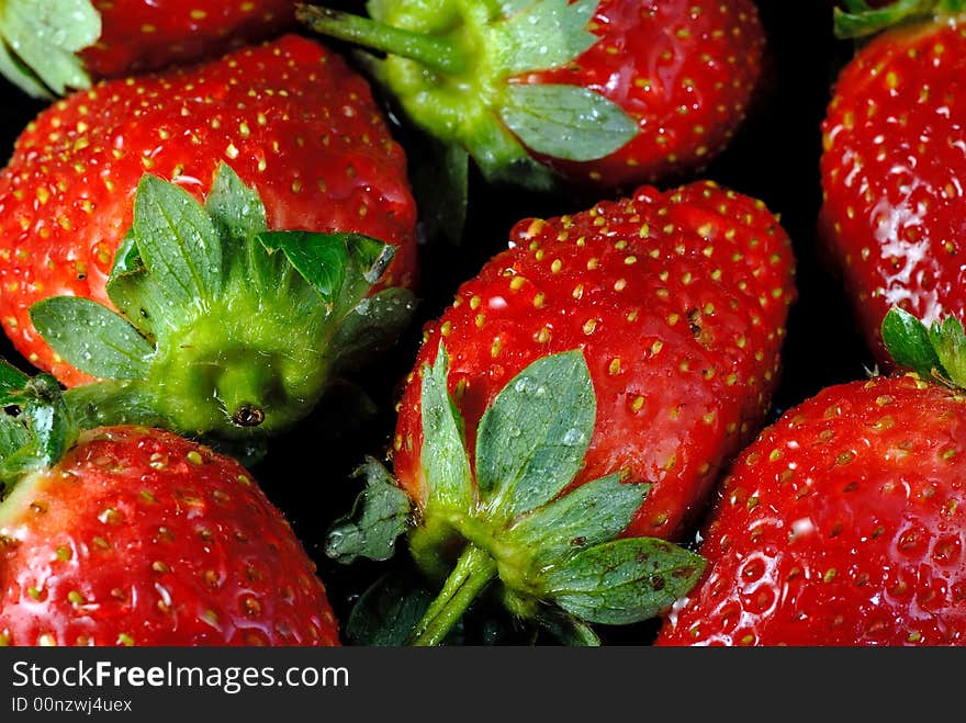 Fresh strawberries on black background