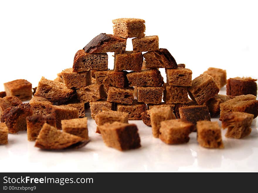 Rye bread croutons wall over white background