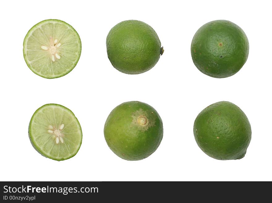 Green limes with one halved isolated on white background