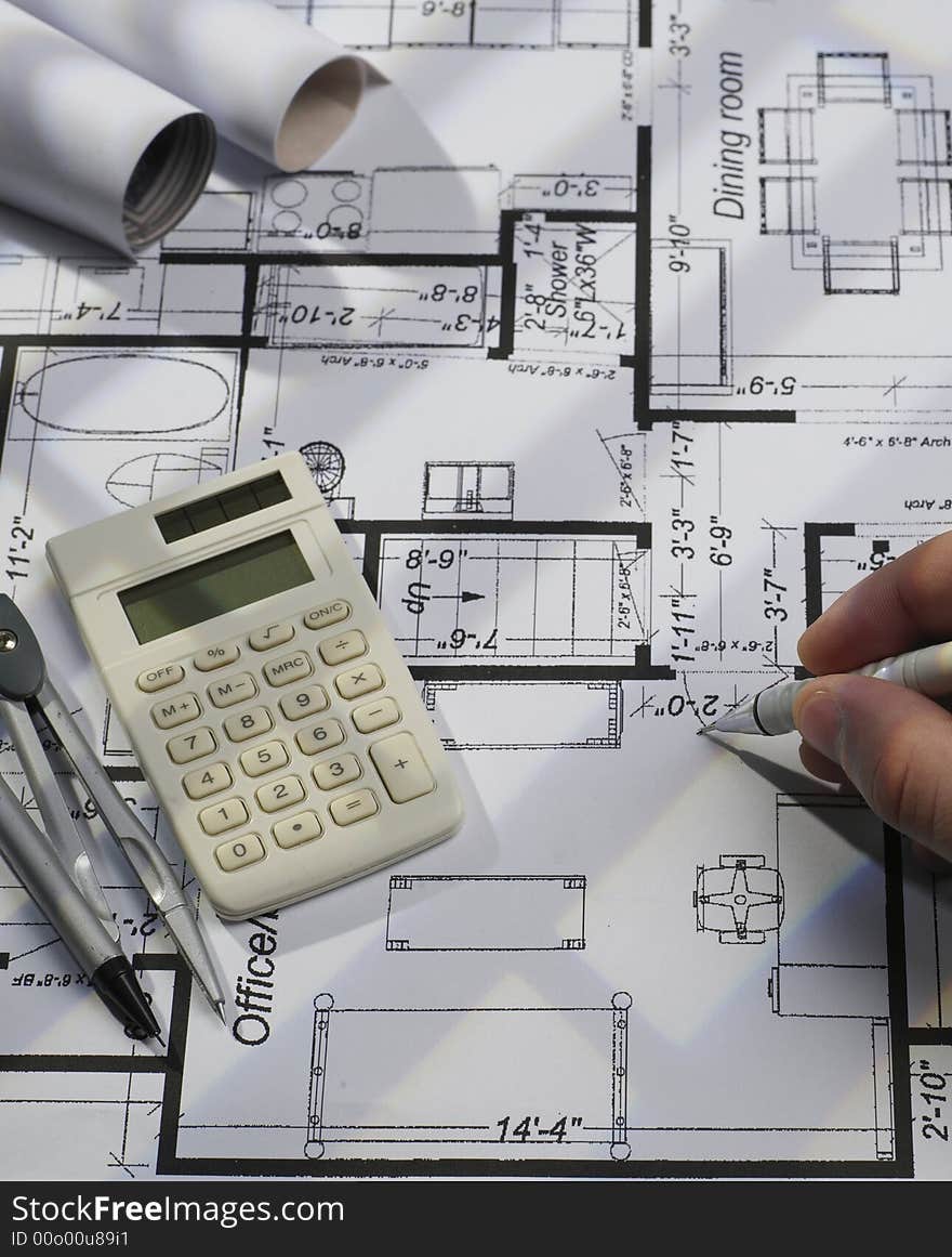 Engineer working on blueprints with pen. Engineer working on blueprints with pen