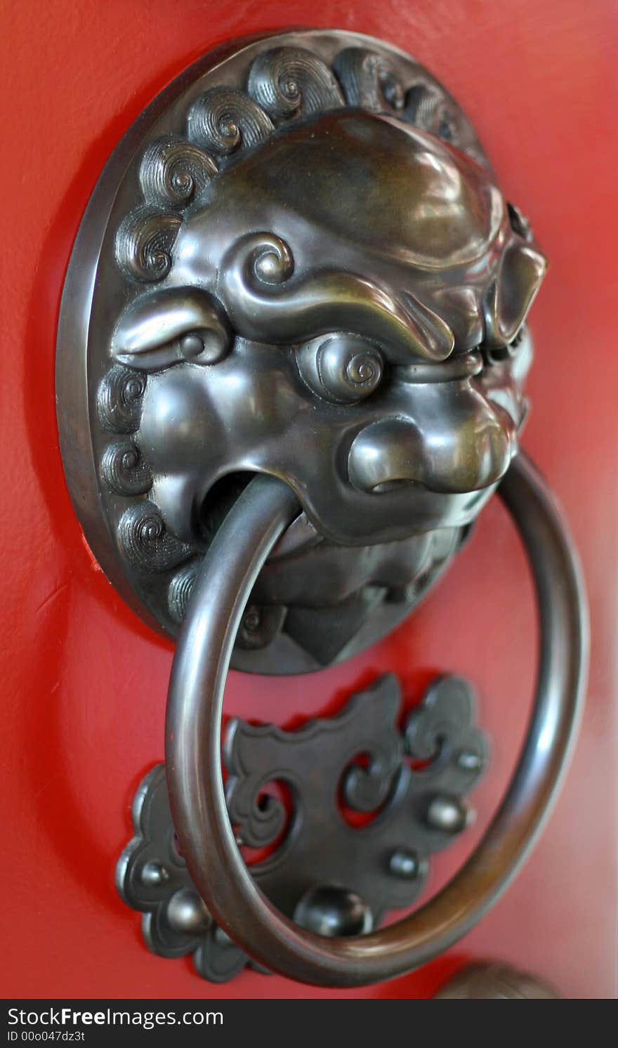 A temple door handle made of metal.