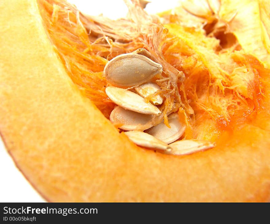 Isolated orange pumpkin with seeds macro close-up. Isolated orange pumpkin with seeds macro close-up