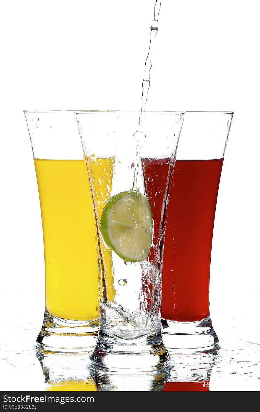 Glasses with juice and lemon on the white background