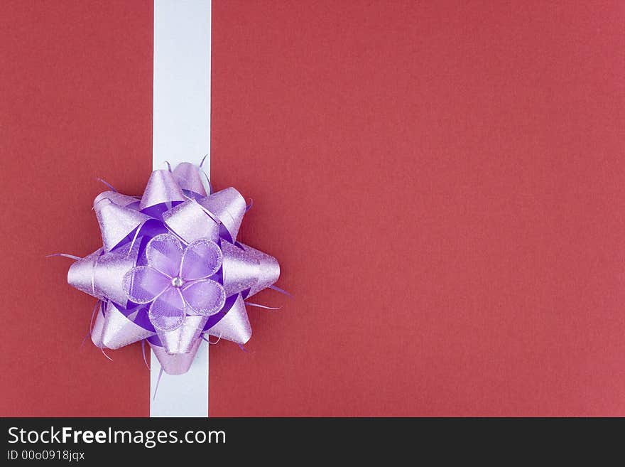 Bow and ribbon on red background