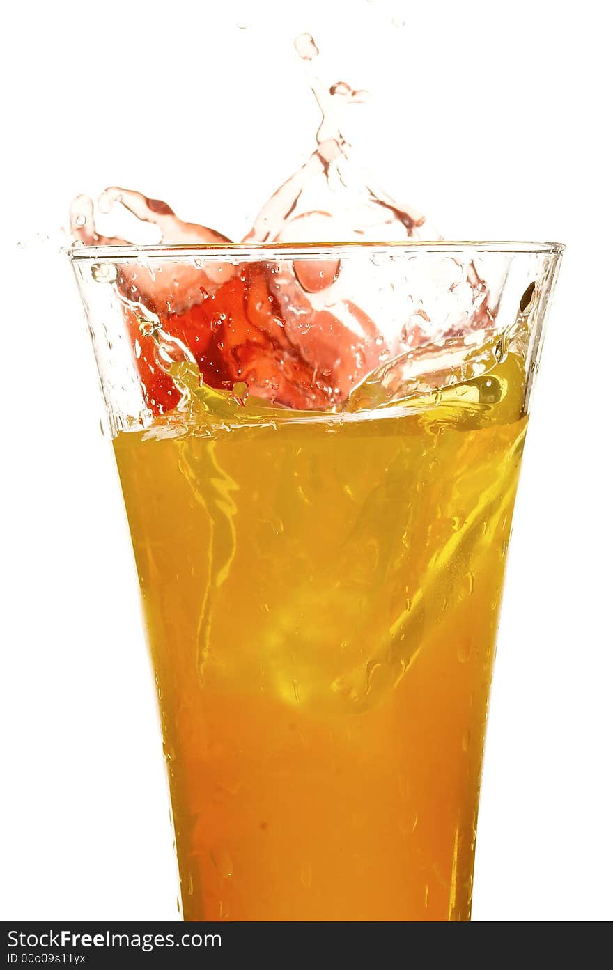 Glass with juice and ice on the white background