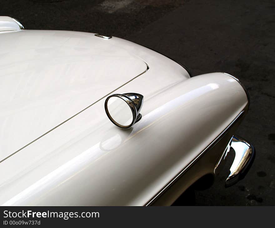 A white old fashined car. A white old fashined car.