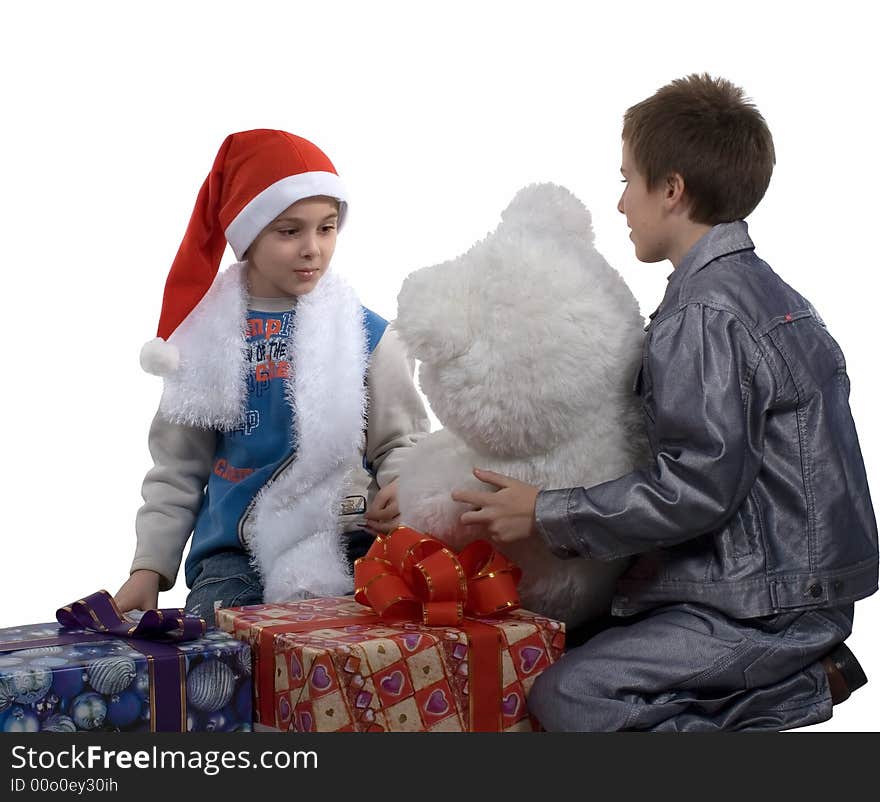 The boy in a cap santa with gifts for friend on a white background. Isolated. Studio. The boy in a cap santa with gifts for friend on a white background. Isolated. Studio.