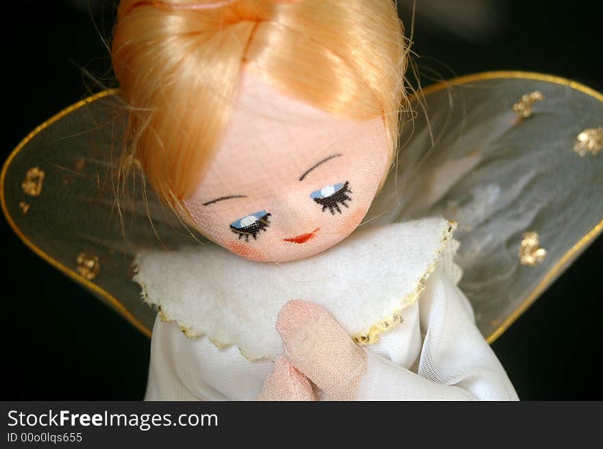 Vintage angel ornament against dark background