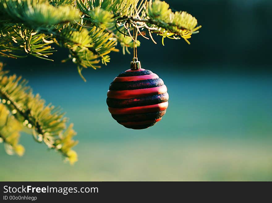 A Christmas ball with red and black and blue backgroubd