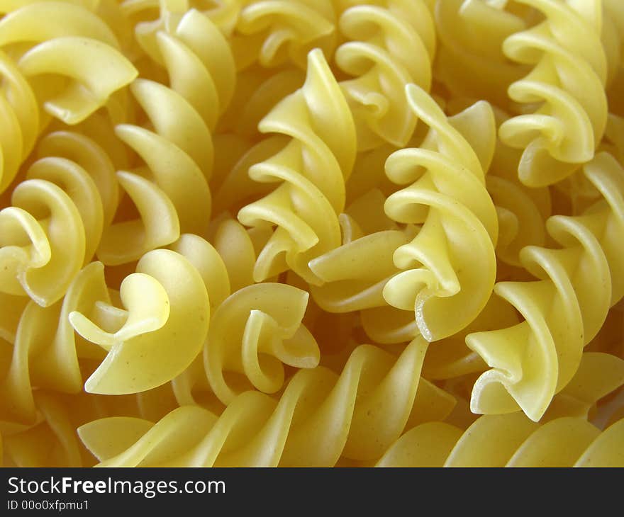 Scattered spiral pasta close-up background