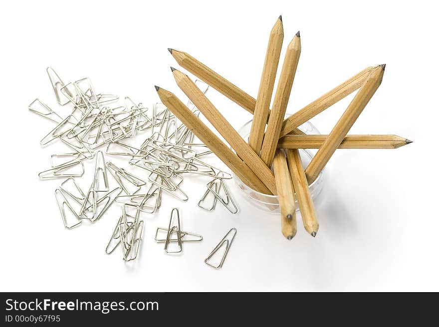 Set of the toothpicks costing in a glass on background of paper clips. Set of the toothpicks costing in a glass on background of paper clips