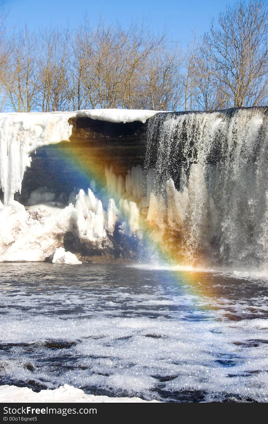 Rainbow over iced waterfall