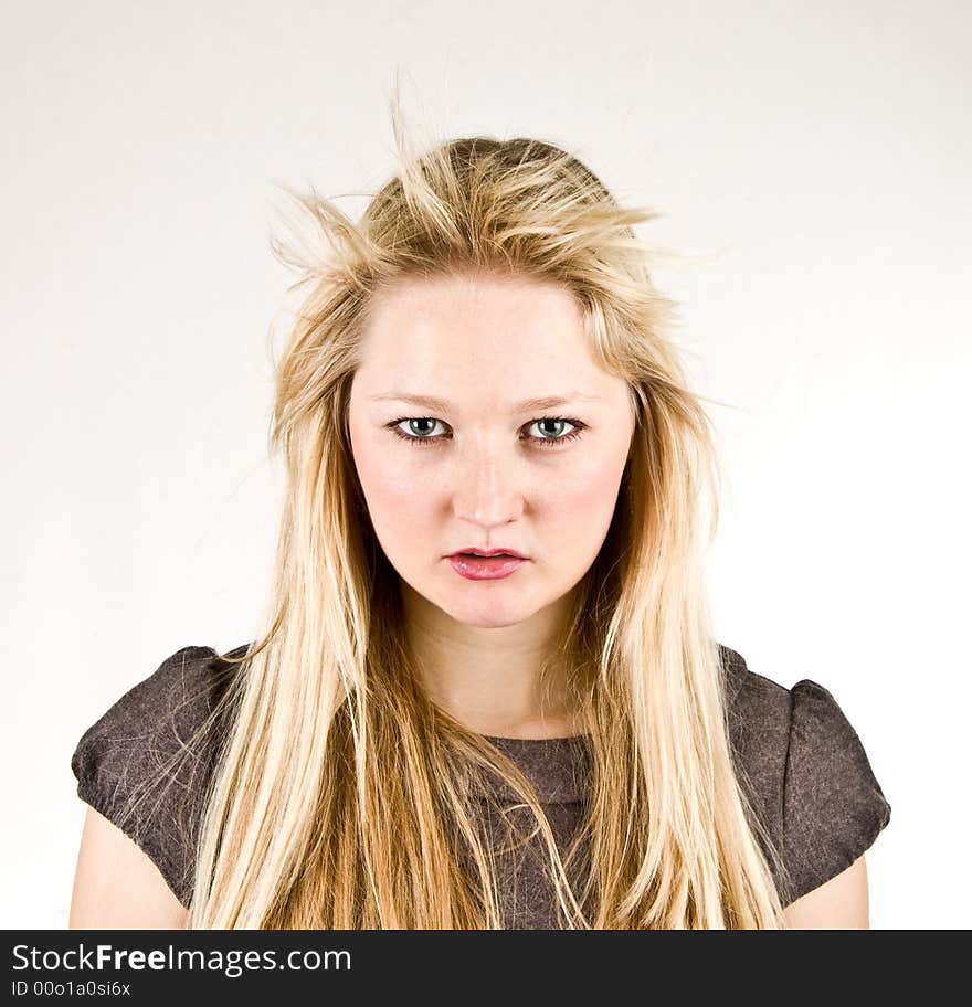 Blond girl studio portrait in strong frontal wind. Blond girl studio portrait in strong frontal wind