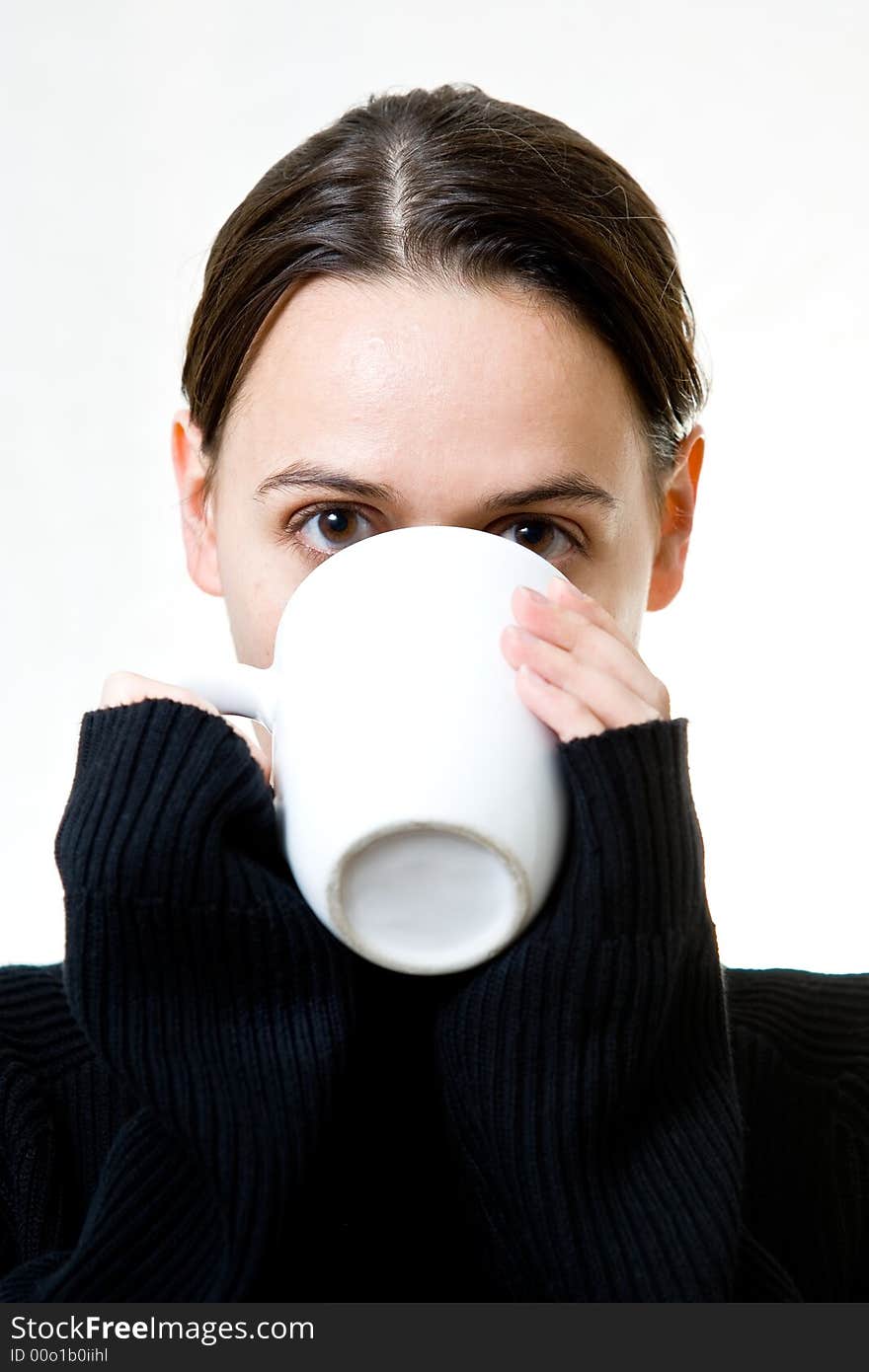 A woman on a white background enjoying a hot drink. A woman on a white background enjoying a hot drink