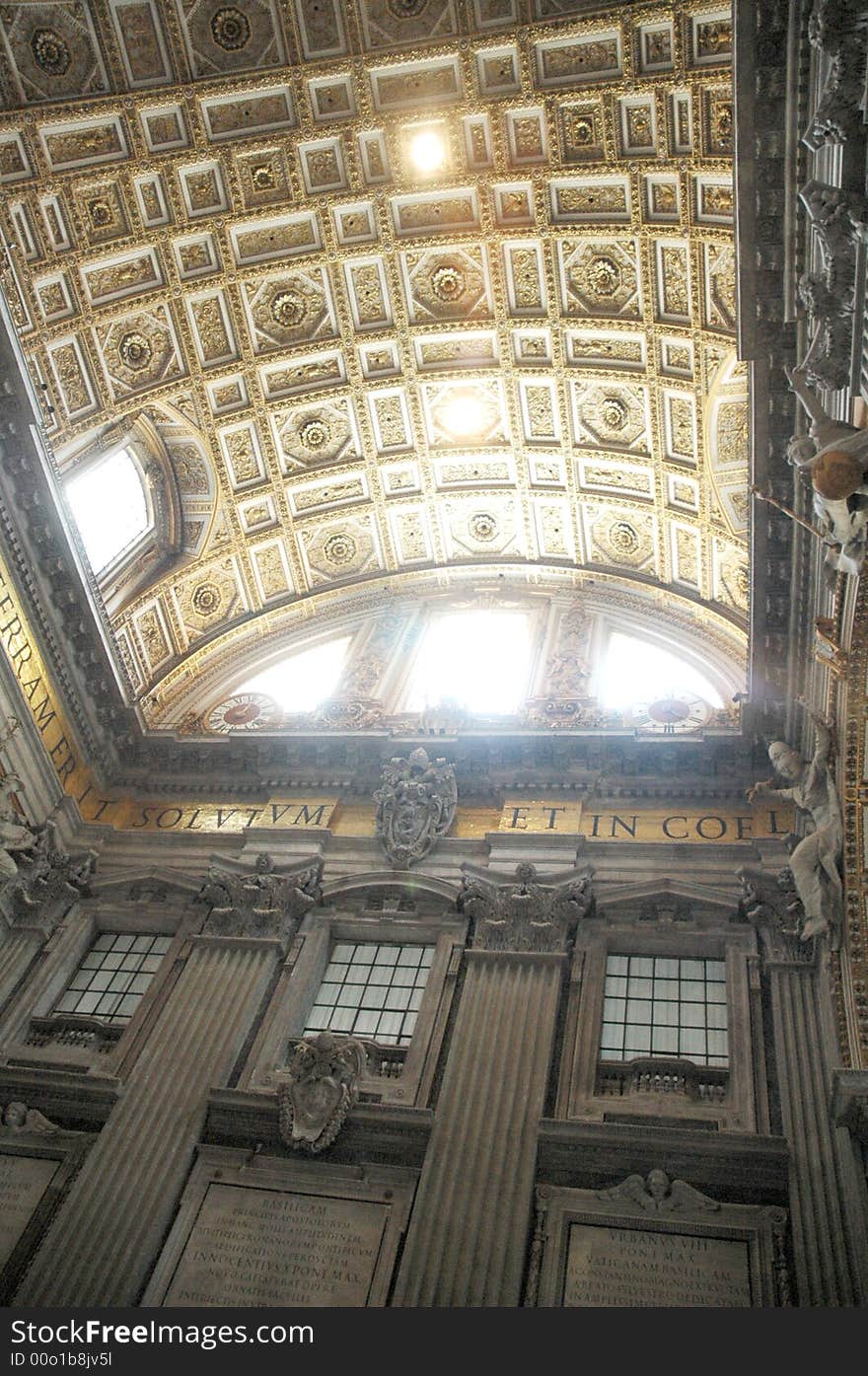 Interior of St.Pier cathedral dome with sun light coming from roof window. Vatican, Italy, EU