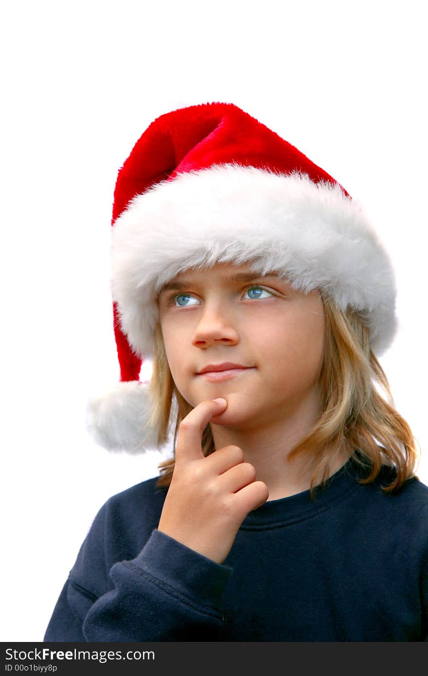 Young boy in santa hat thinking of christmas list. Young boy in santa hat thinking of christmas list.