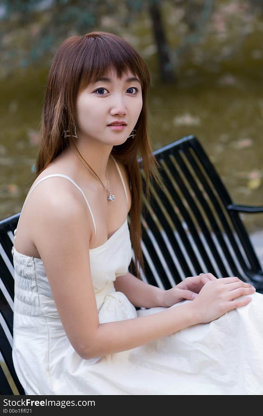 A girl with eyes of hope sitting on campus in deep autumn