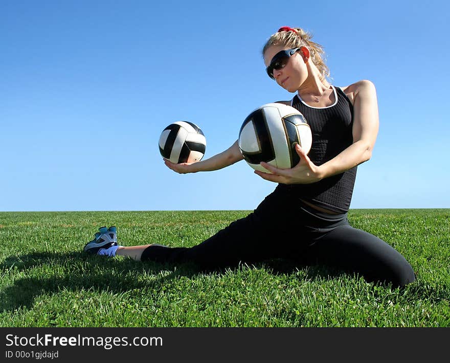 Young pretty woman exercising on green grass. Young pretty woman exercising on green grass