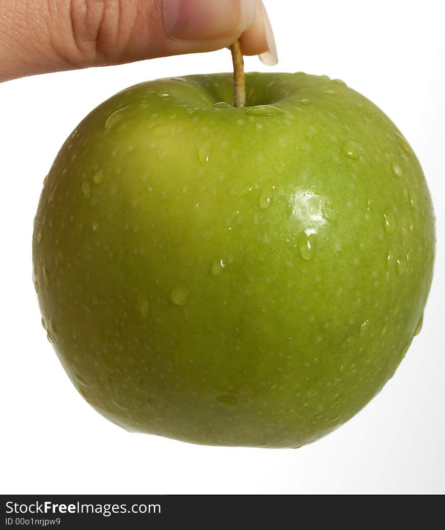 Holding a fresh green apple over a white background. Holding a fresh green apple over a white background