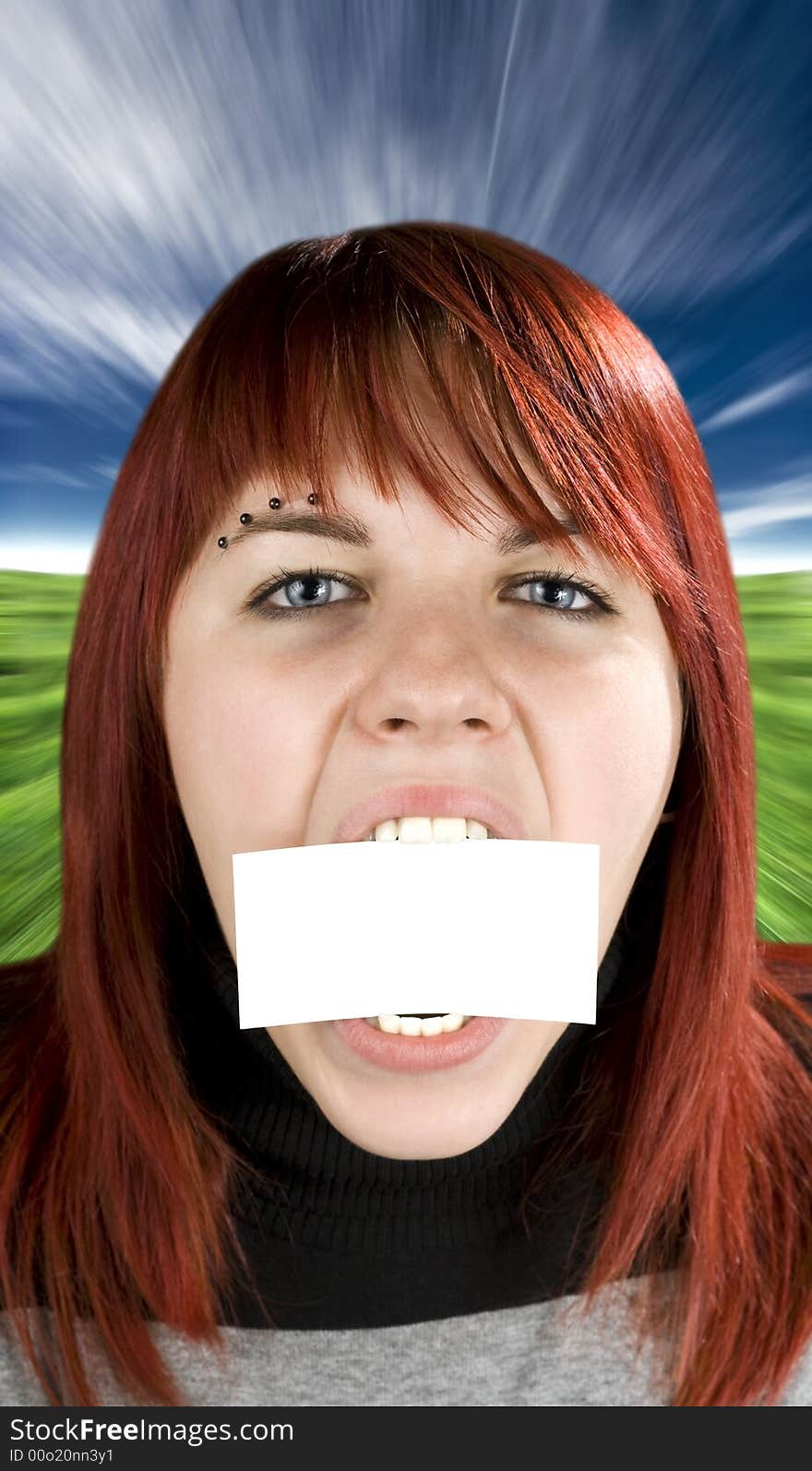 Redhead girl aggressively biting or eating a blank greeting card. Concept expresses nutrition or eating disorder problems. Studio shot. Studio shot. Redhead girl aggressively biting or eating a blank greeting card. Concept expresses nutrition or eating disorder problems. Studio shot. Studio shot.