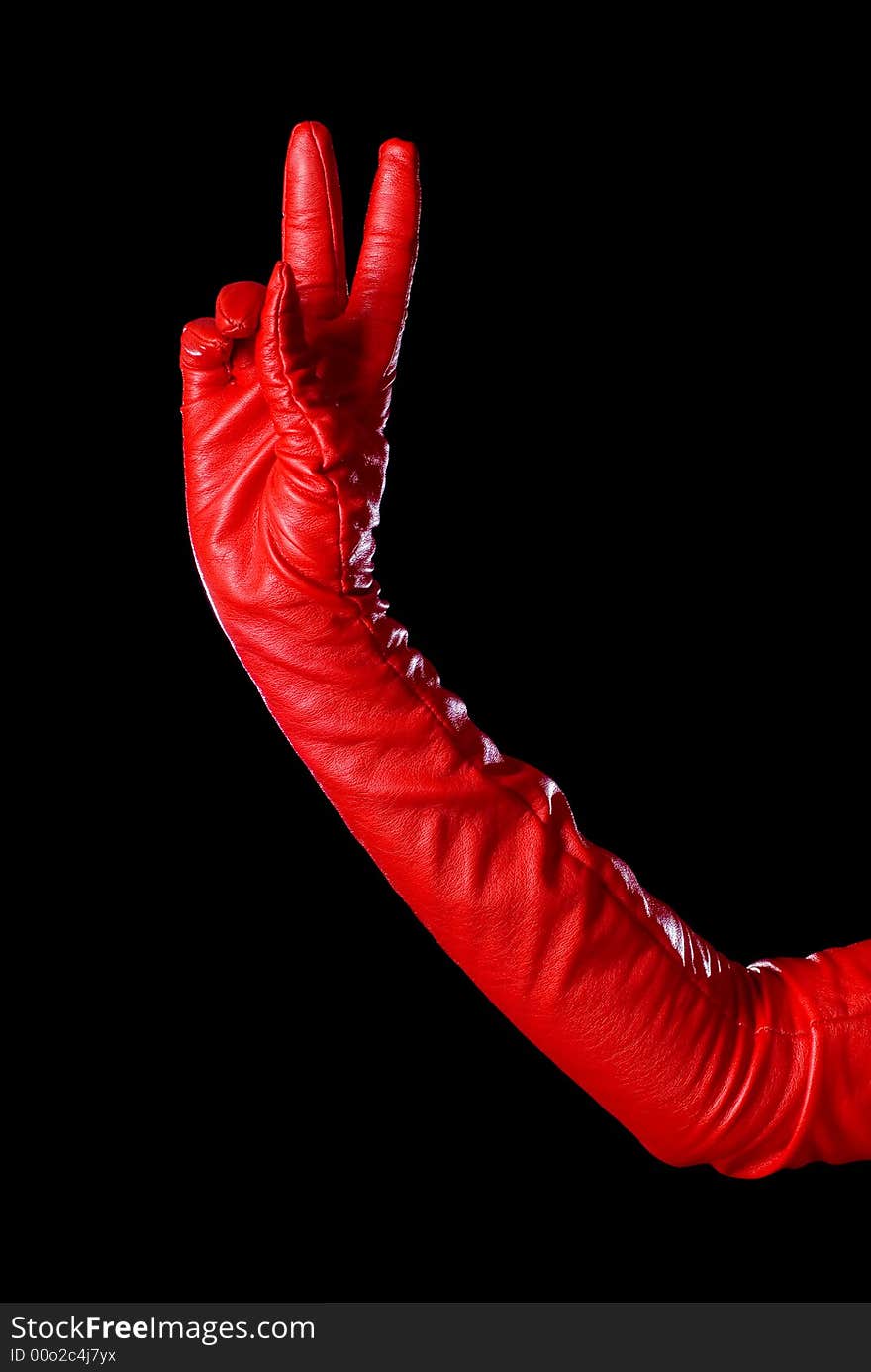 Hand in red glove on the black background counting two. Hand in red glove on the black background counting two