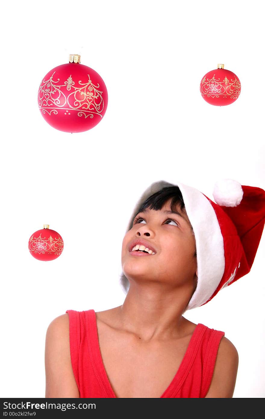 Cute little asian boy as santa claus watching the baubles. Cute little asian boy as santa claus watching the baubles