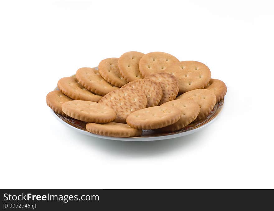 A plate of salty crackers isolated on white