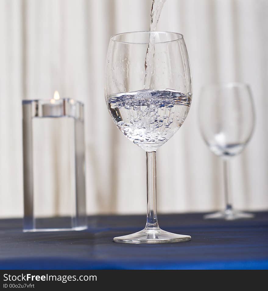 Pouring water in a glass (restaurant scene). Pouring water in a glass (restaurant scene).